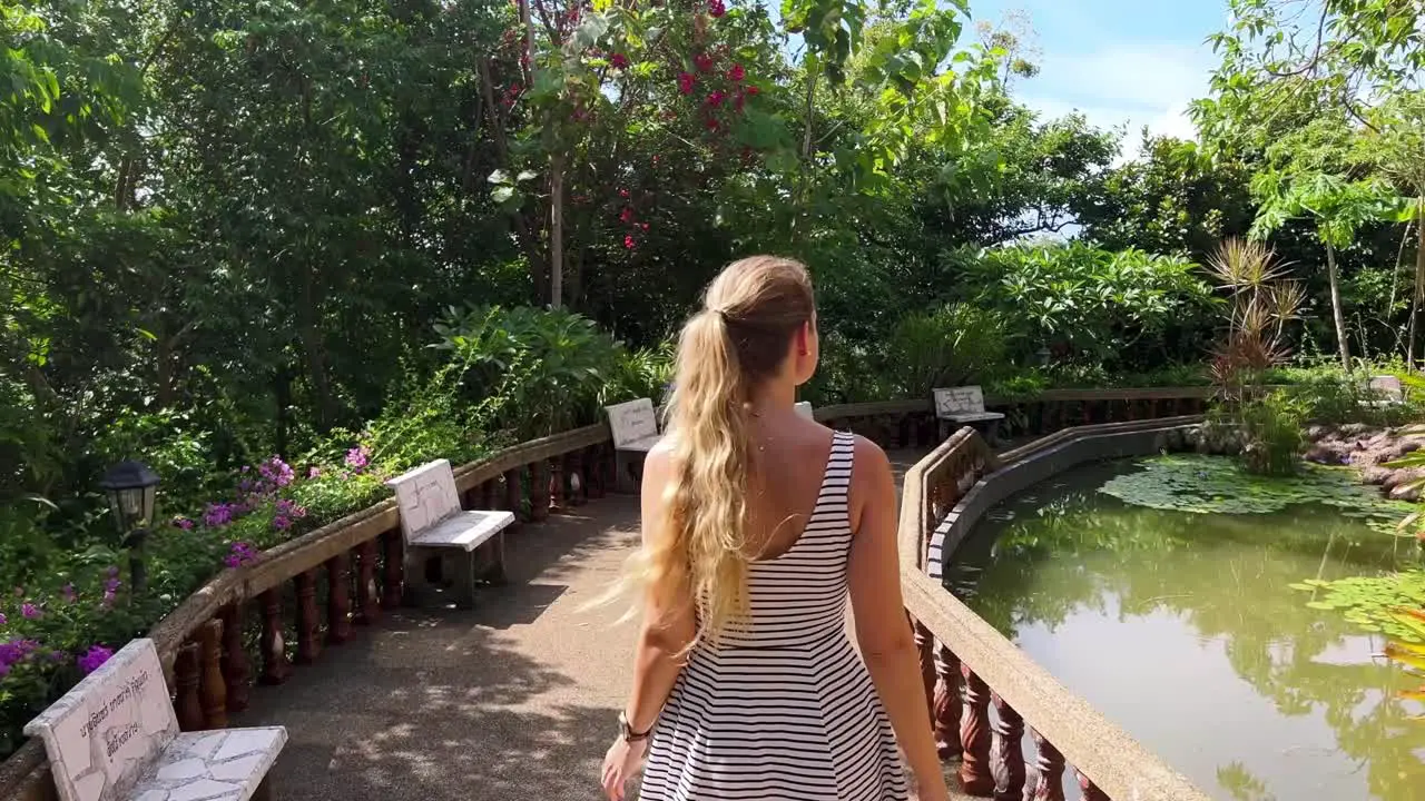 A blonde girl is walking back from a Buddhist shrine