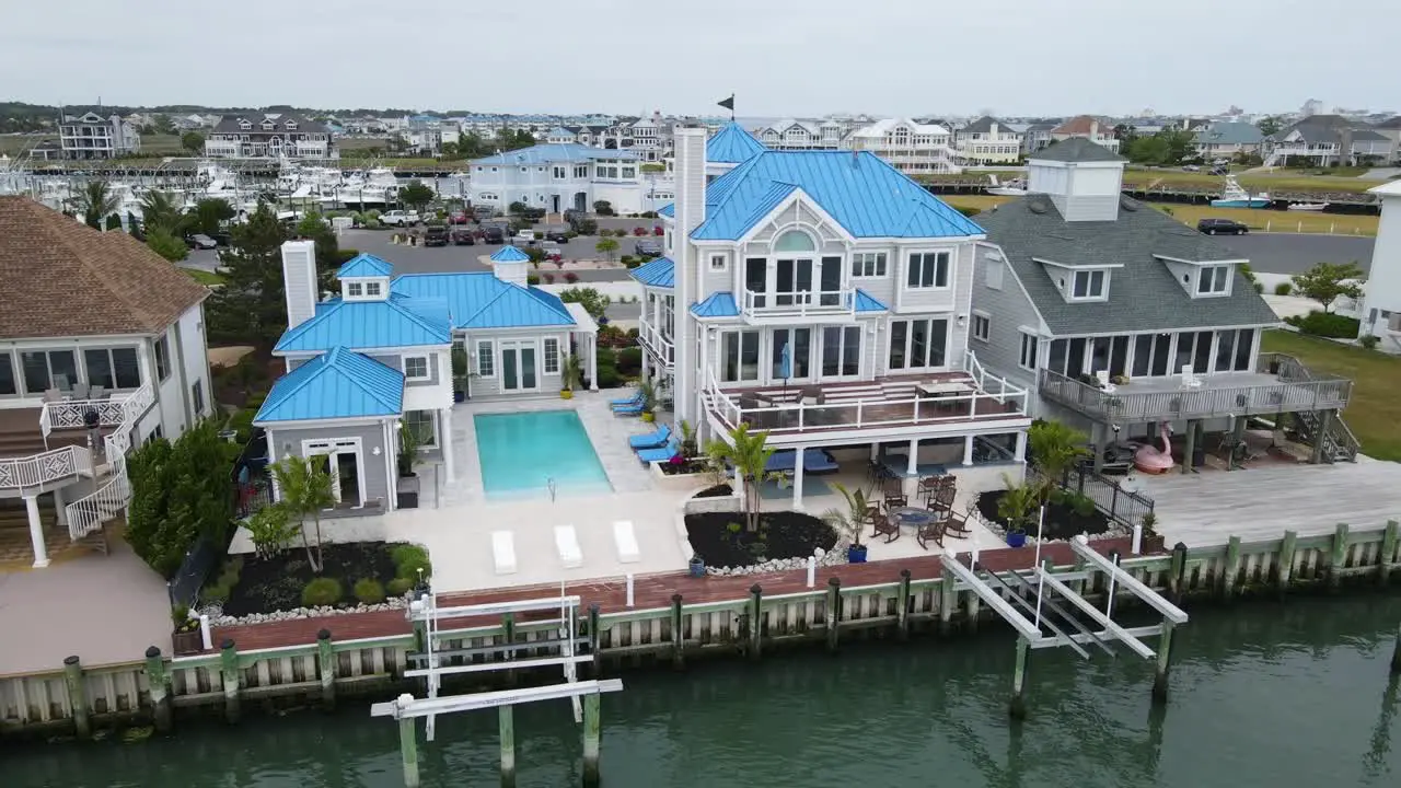 A smooth drone shot overlooking a beautiful mansion near Assateague Island