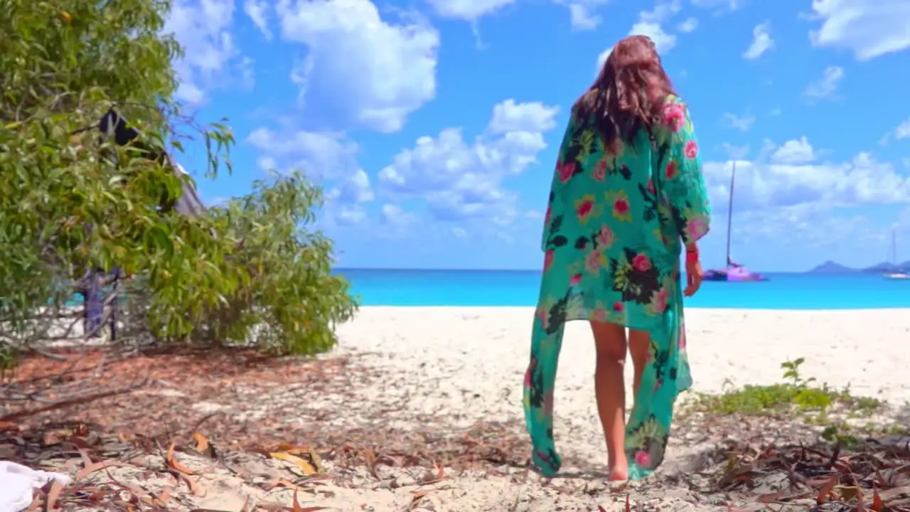 Girl walks in slow motion on a blue beach