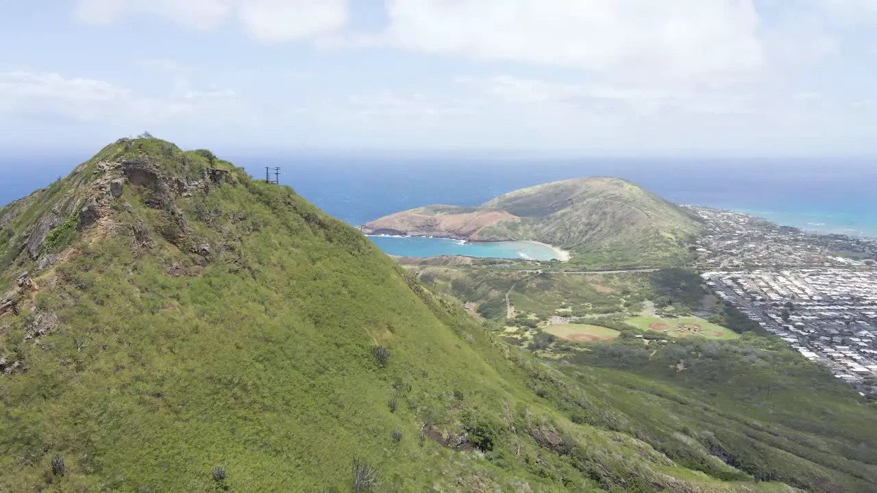 Mountain range on a tropical island with ocean water in background and a peninsula