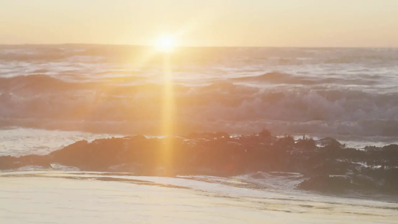 Video of calm sunset over ocean waves and beach