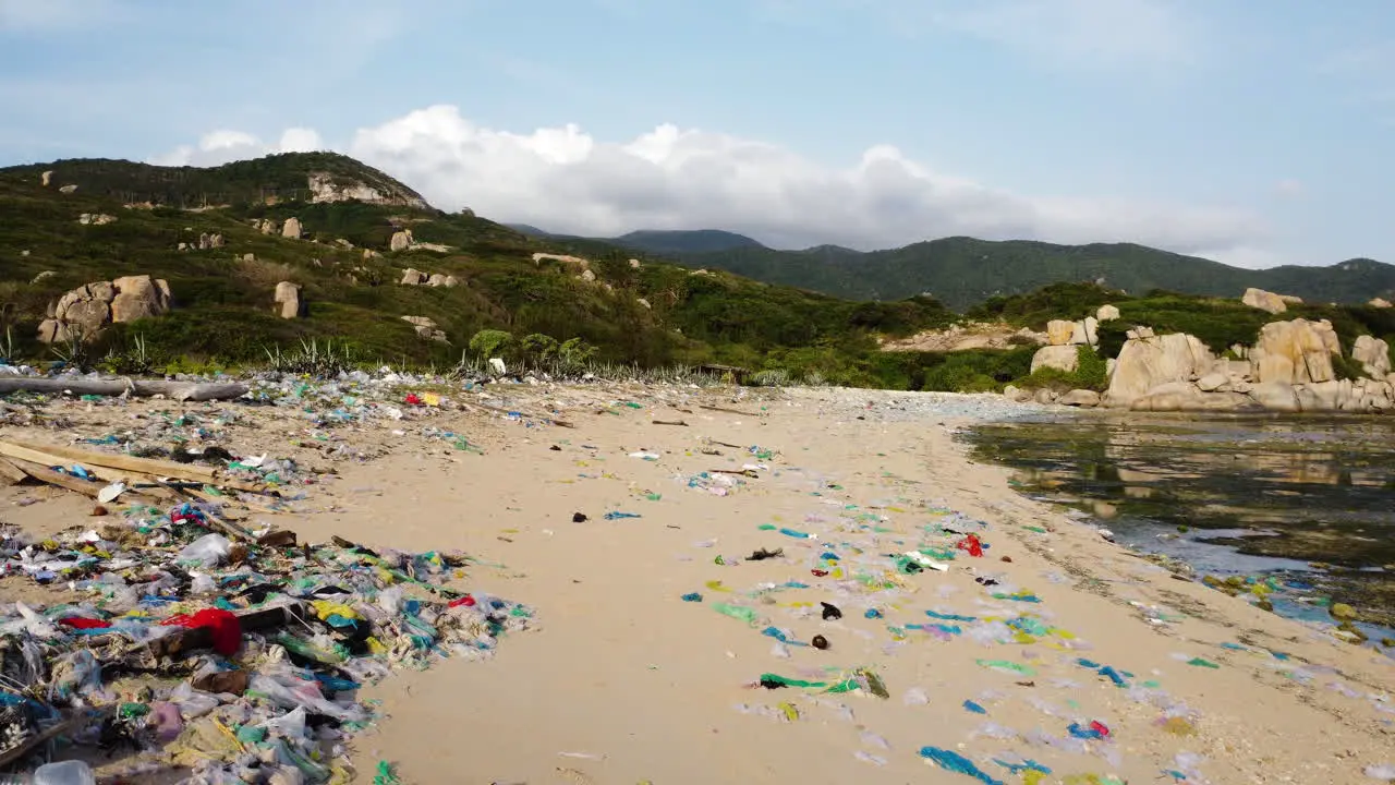 Aerial view ocean pollution in Asia drone reveal piles of plastic waste and garbage trash on a sandy tropical beach in Vietnam