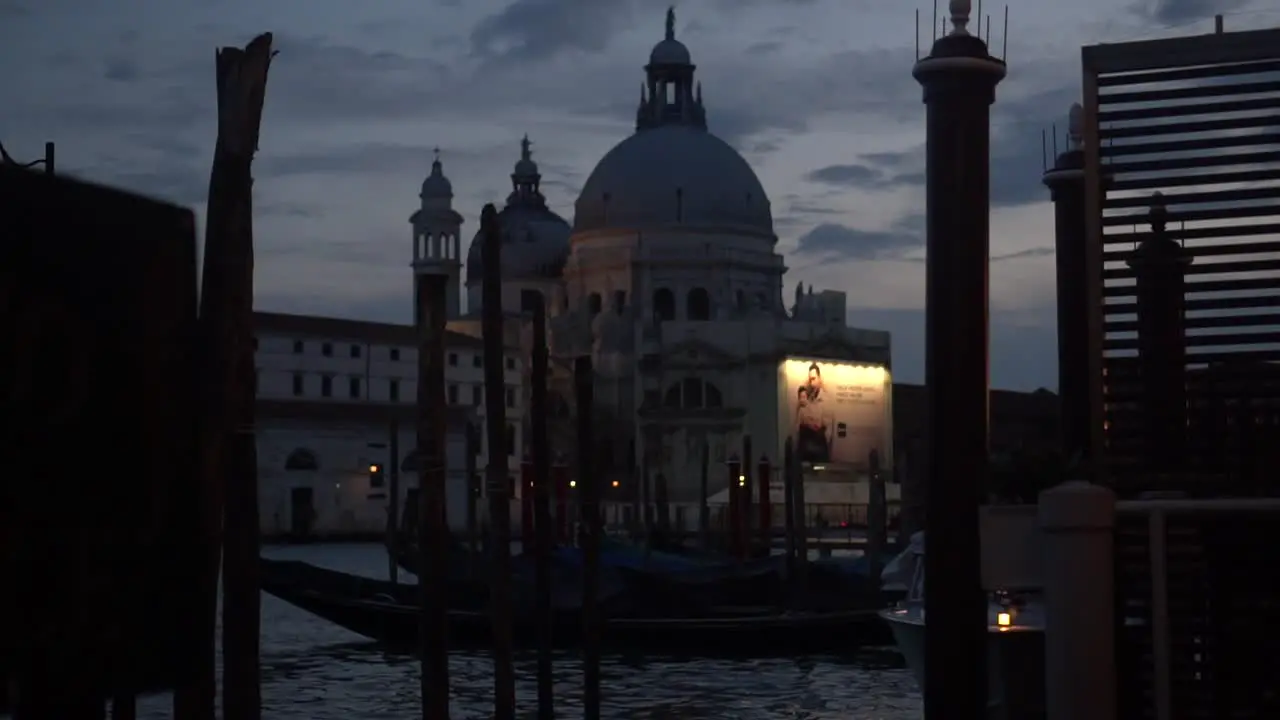 Historical building in Venice viewed from a dock illuminated by the nighttime light nocturnal view street scene