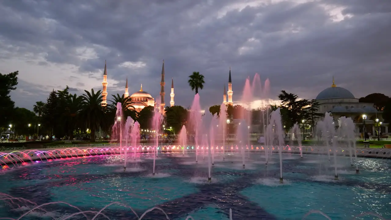 Sultanahmet water fountains illuminated at night with Blue mosque Istanbul