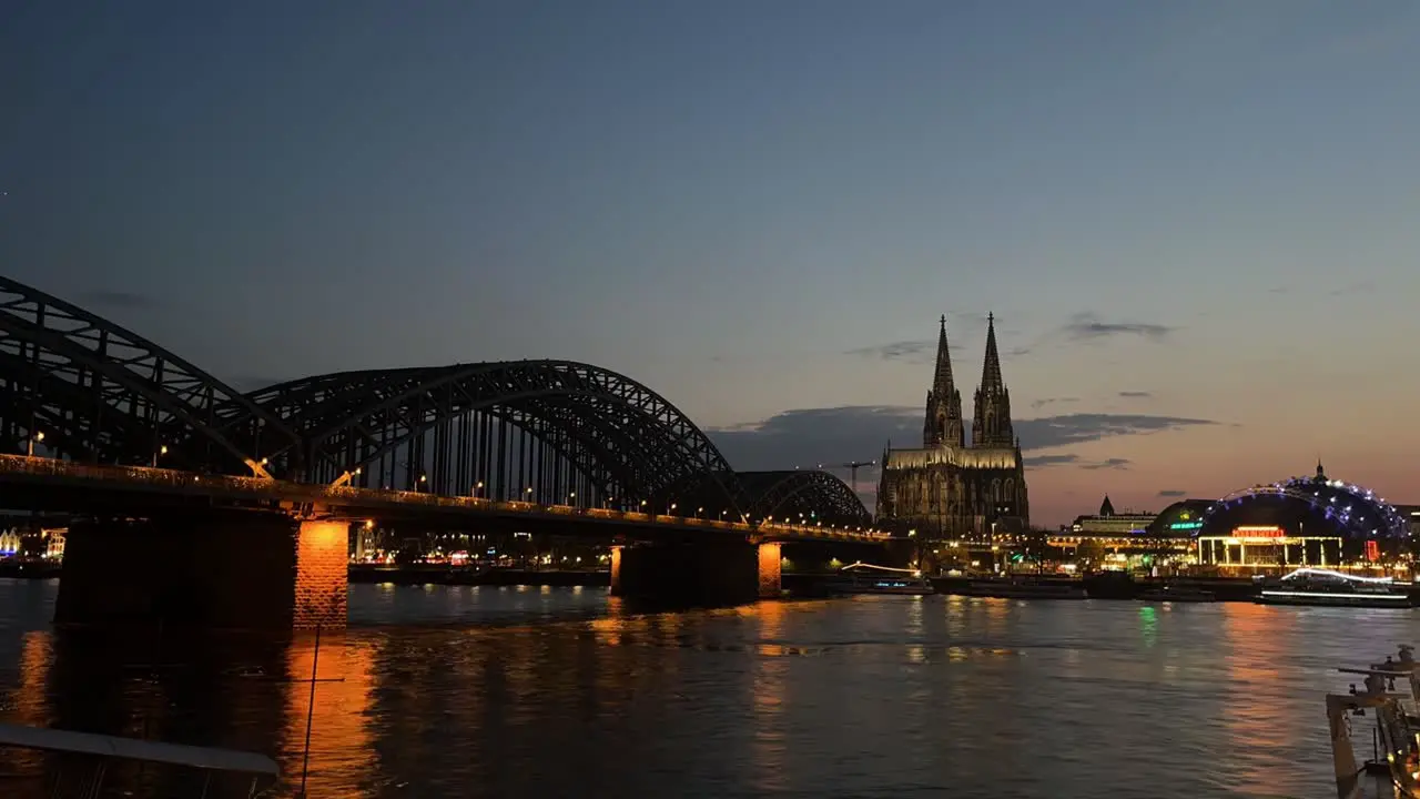 timelapse of cologne at night with cathedral and bridge