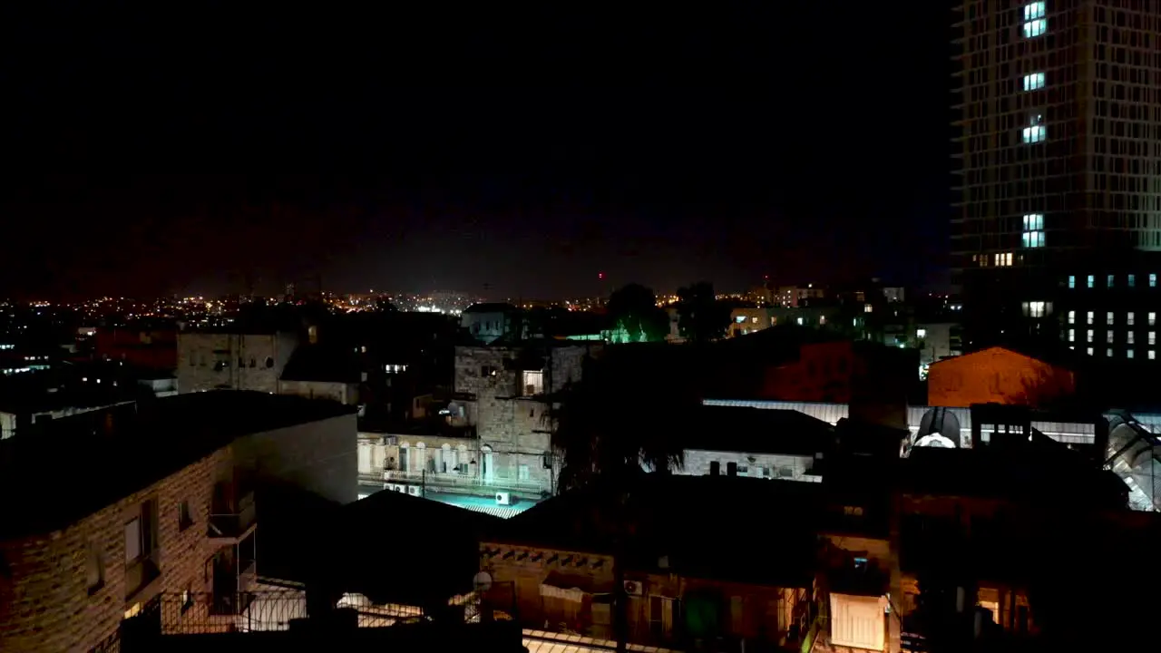 Jerusalem city lights reveal at night aerial shot