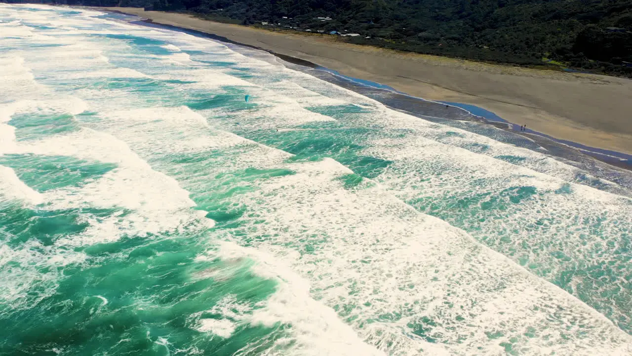 Scenic View of Kitesurfing On Ocean Waves At Piha Beach in New Zealand