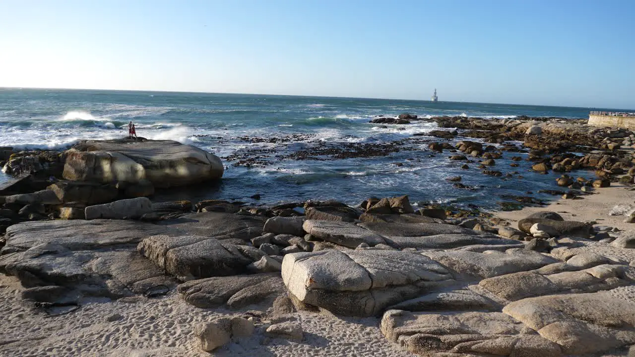 Wide shot of Bantry Bay South Africa in late afternoon sunlight on a blue sky day at the Atlantic Ocean