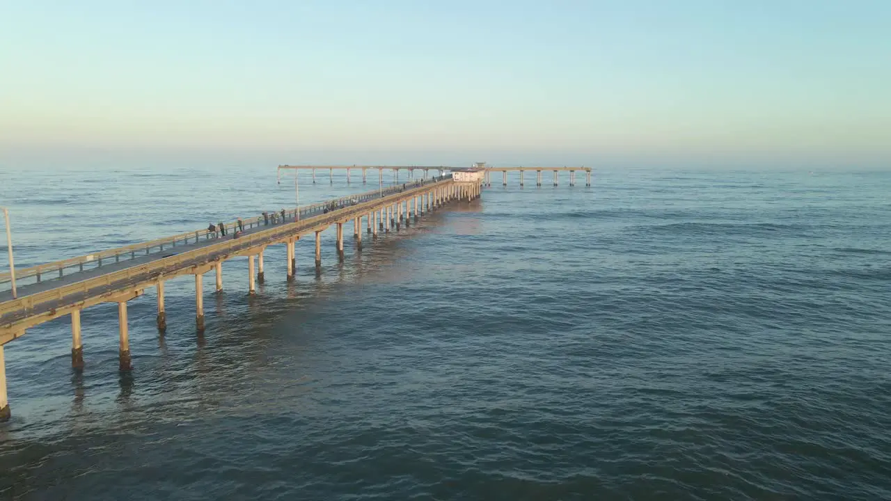 Drone flying down the Ocean Beach Pier in San Diego California