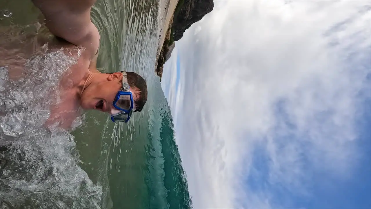 Man Playing in Shorebreak Ocean Waves on Fun Hawaii Beach Vertical