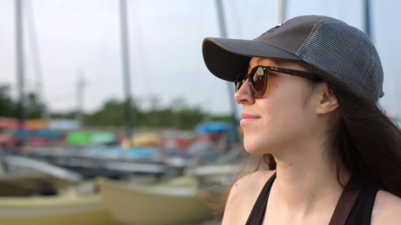 Young Girl Wearing A Cap And Sunglasses Looking Afar And Enjoying The View