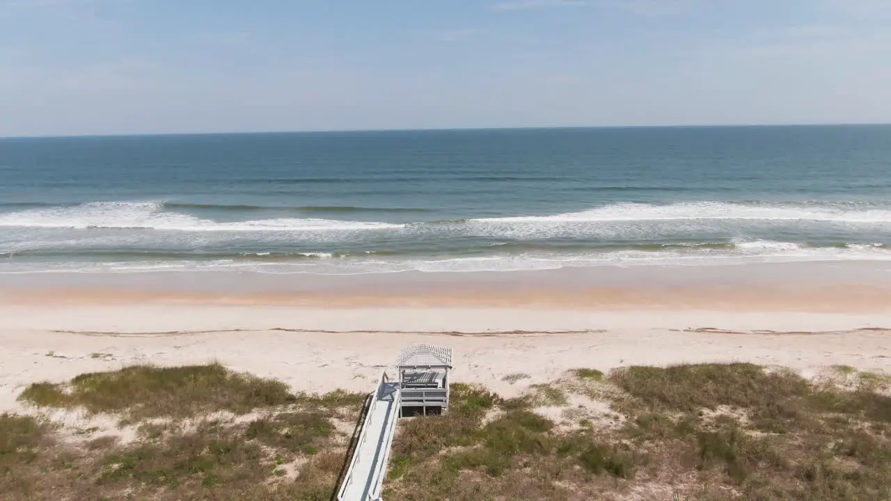 Push in over beach to waves crashing onto the beach from the ocean in Ponte Vedra Florida