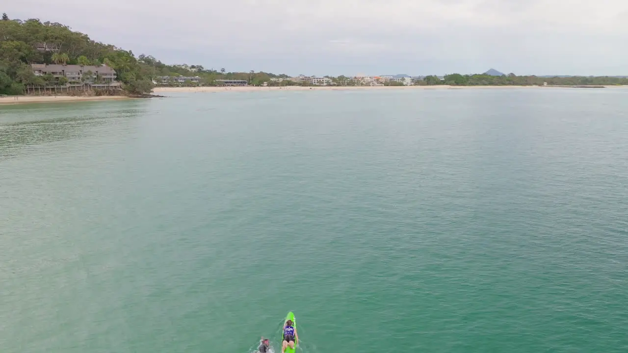 Aerial Drone Above Ocean Swimmer Training With Coach Off Noosa Main Beach Shore 4K Australia Slow Motion