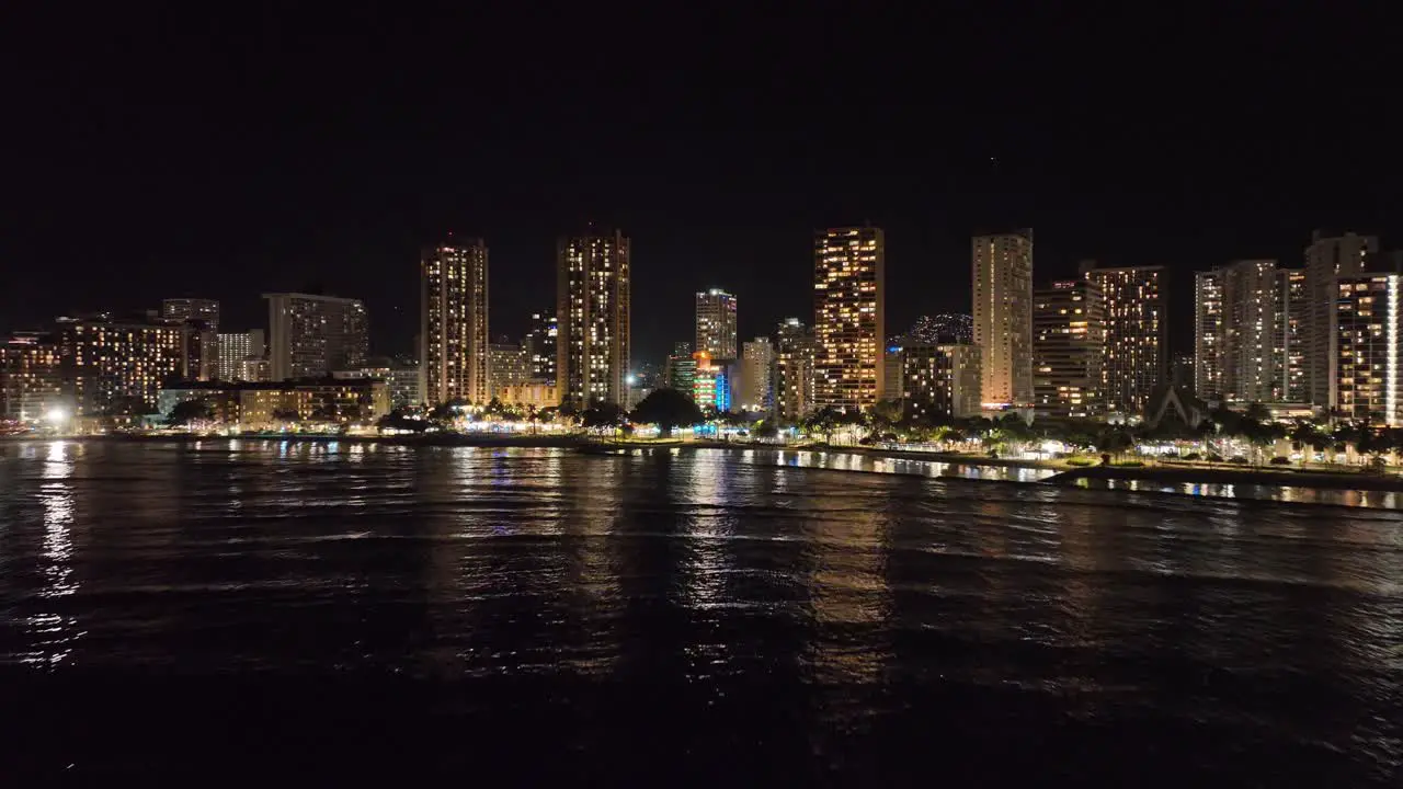 30 fps waikiki honolulu city skyline drone at night on oahu hawaii aerial