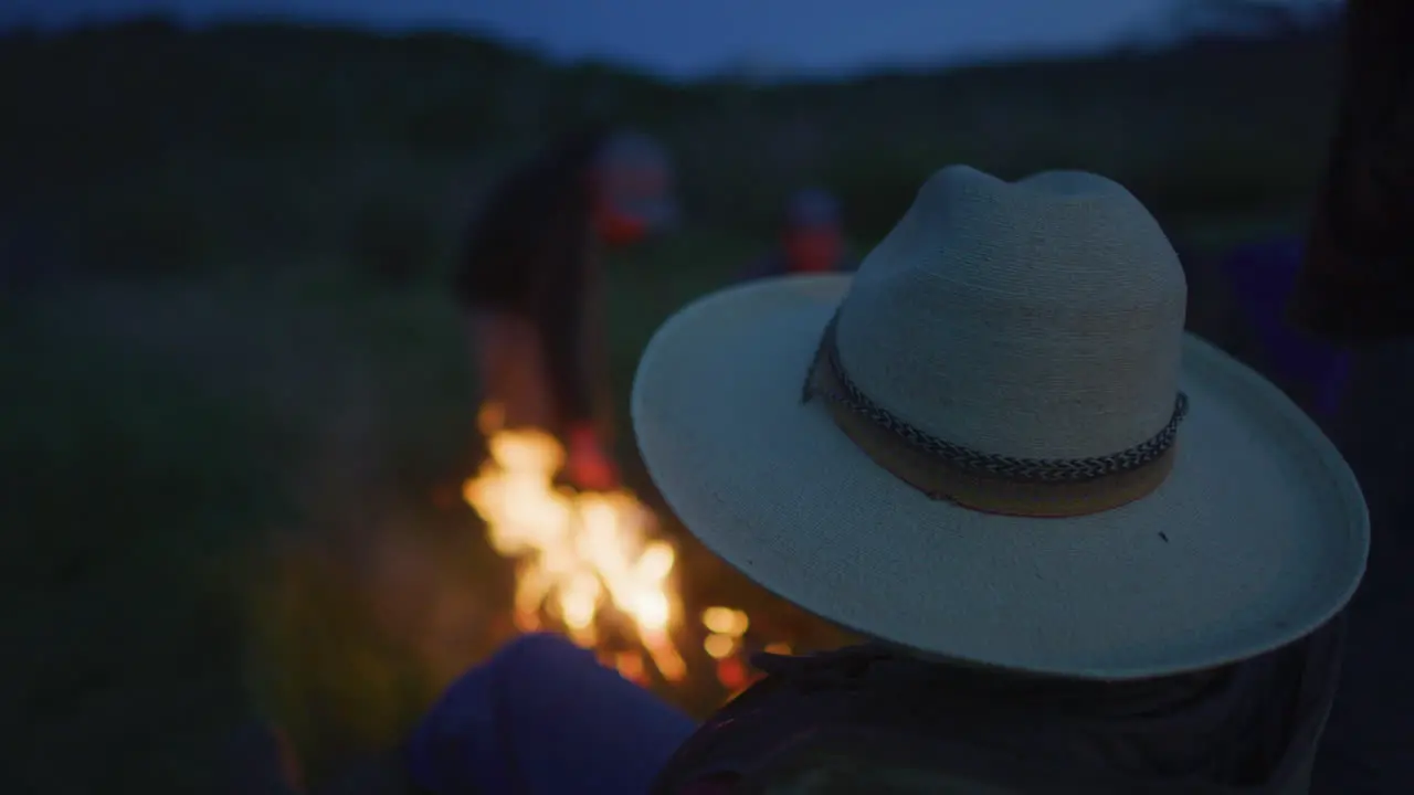 Group enjoying Campfire Fire at Dusk Evening Night in Slow Motion