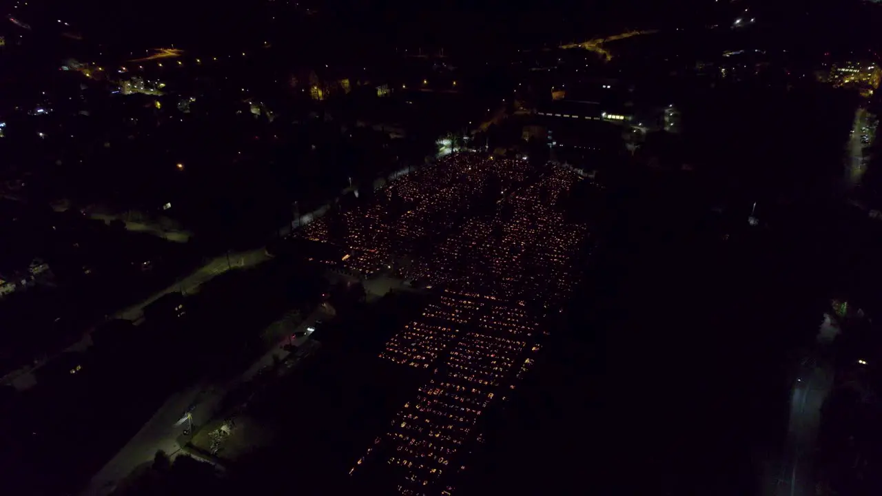 Aerial view of huge graveyard illuminated by candles