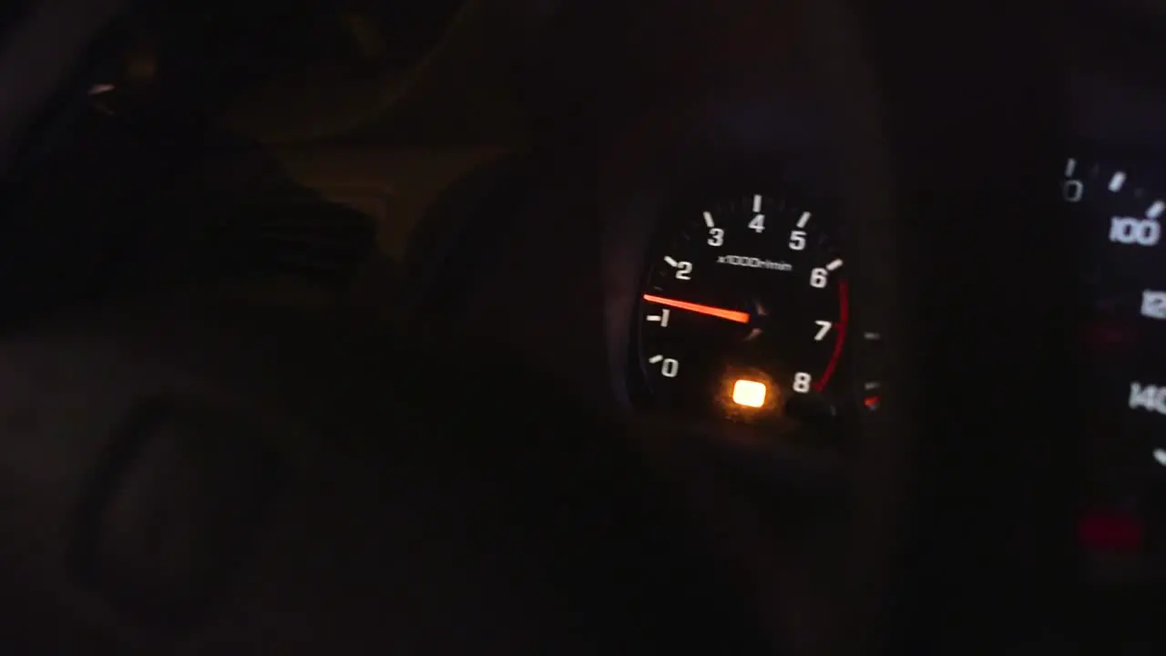 RPM Gauge car engine reving low RPMs through steering wheel