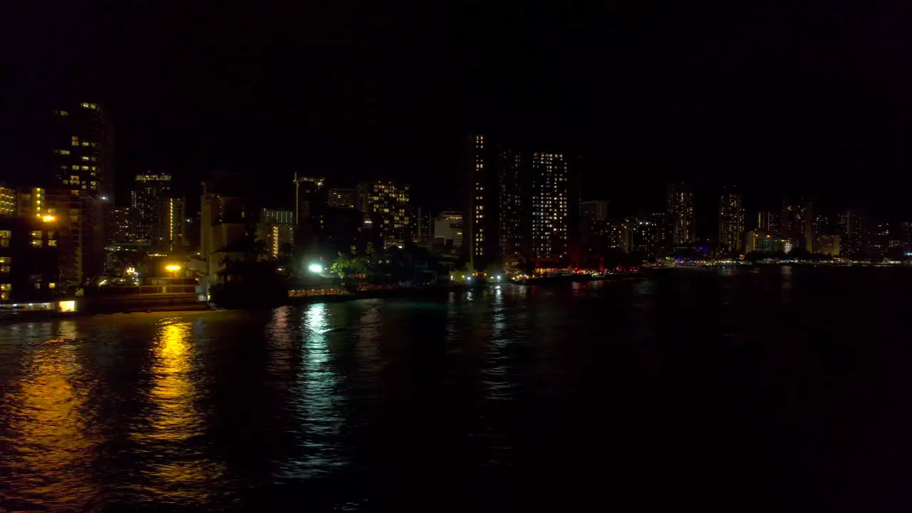 Aerial night view of Honolulu cityscape at Waikiki Beach