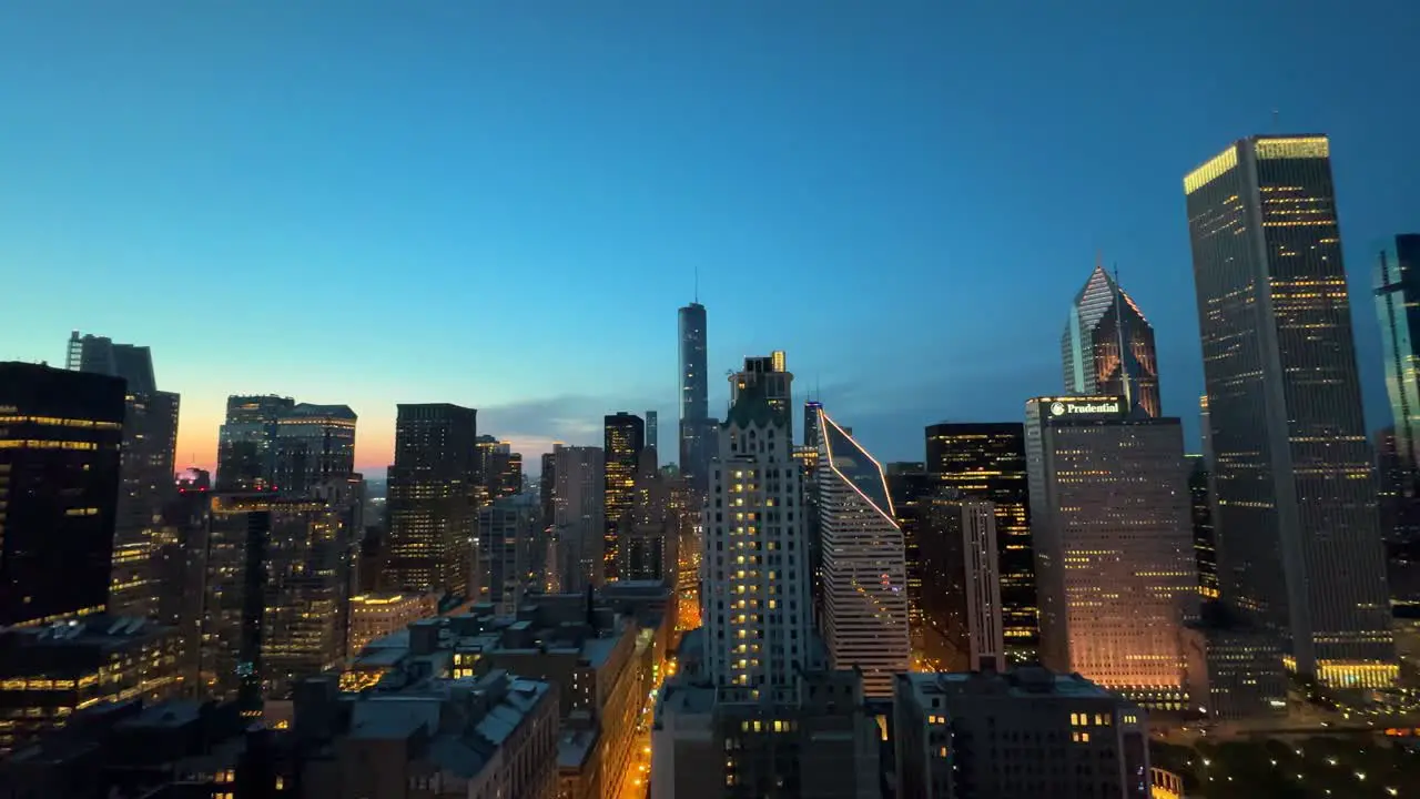 Pan of downtown Chicago from skyscraper night dusk