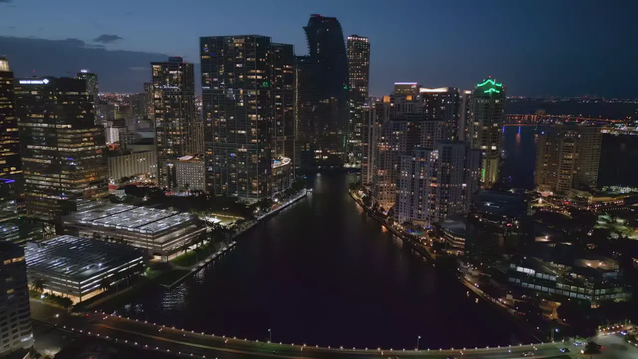 Aerial of Modern Downtown Miami Skyscrapers at night over the bridge by drone