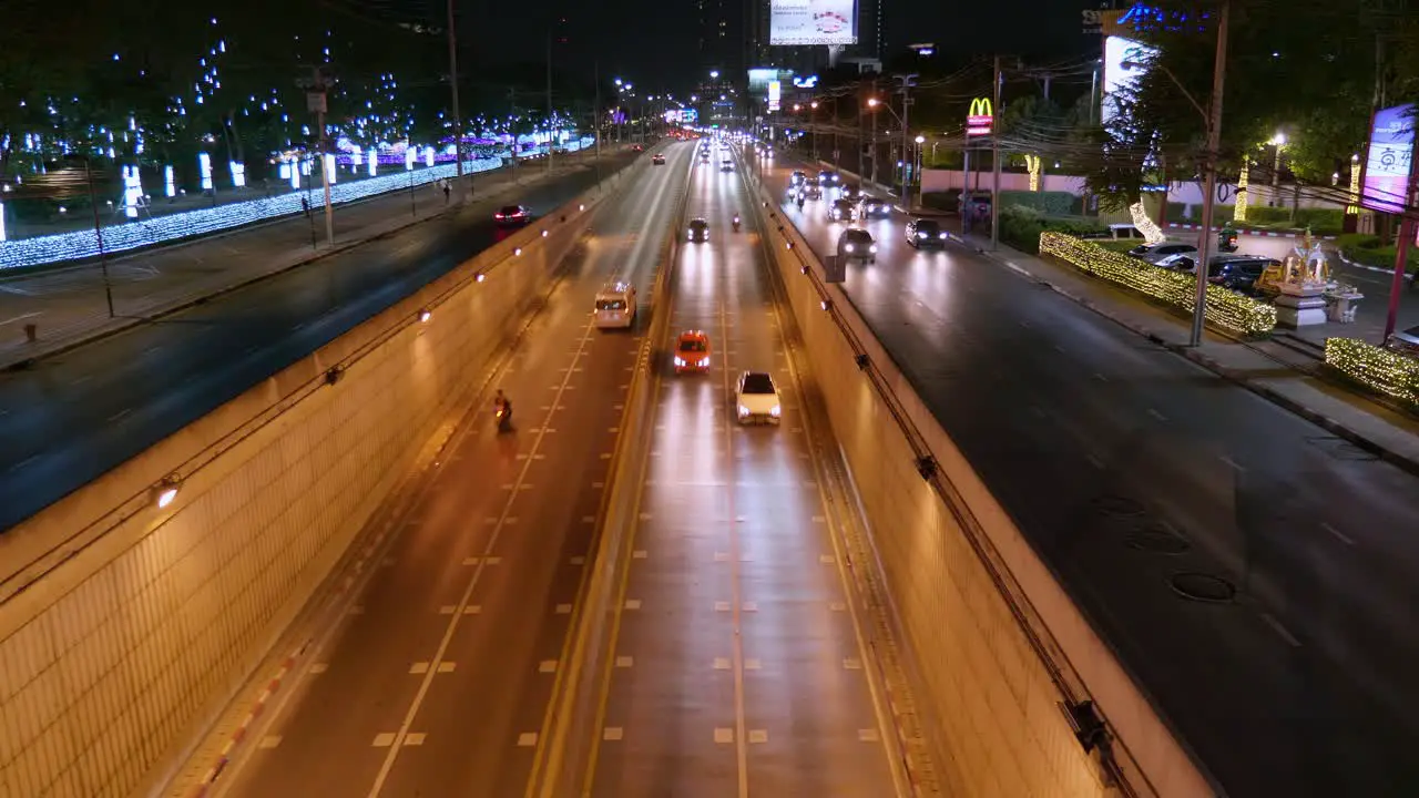 Tunnel close to the city with a lot of cars moving at night in Bangkok Thailand