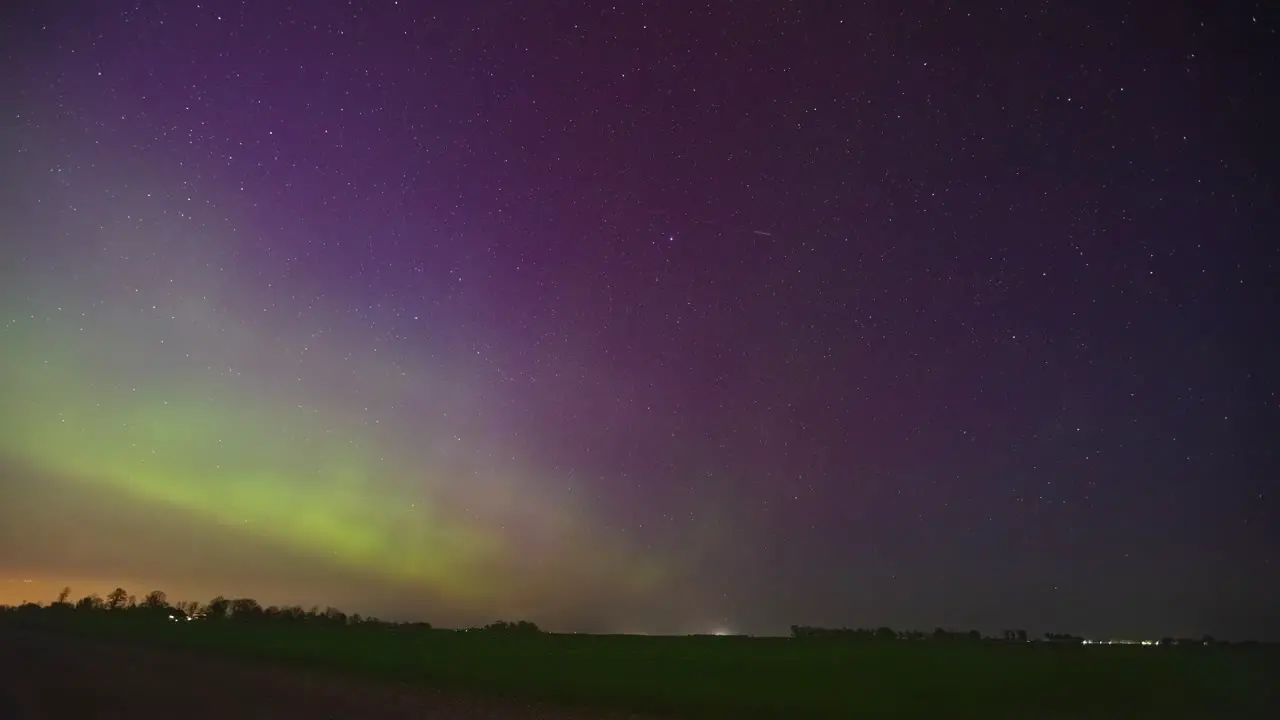 Brilliant colors and shapes of the aurora borealis in the nighttime sky time lapse