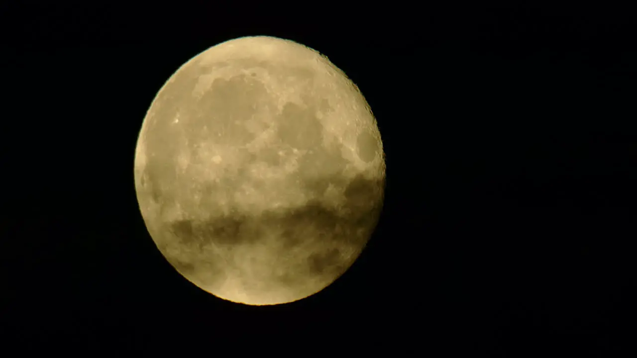 Full moon being covered by dark clouds