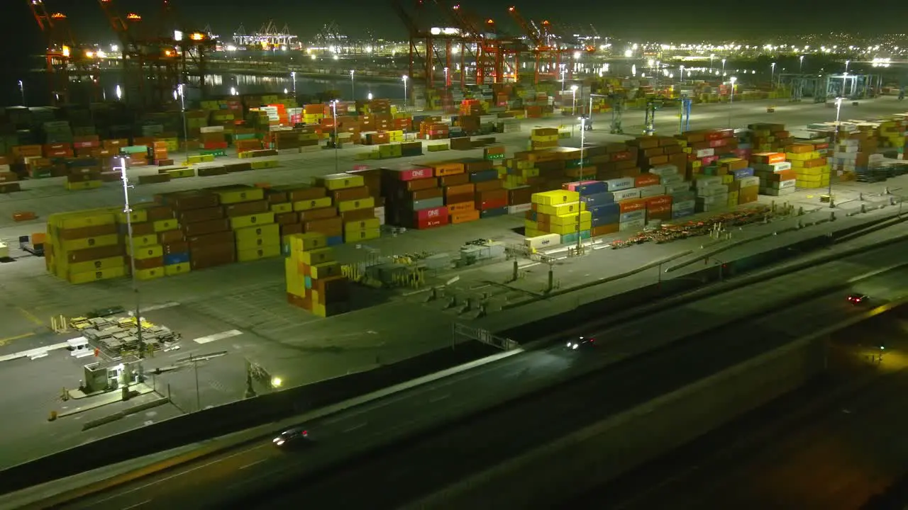 Overhead flyby of Long beach shipping port | Night time | Ocean in background