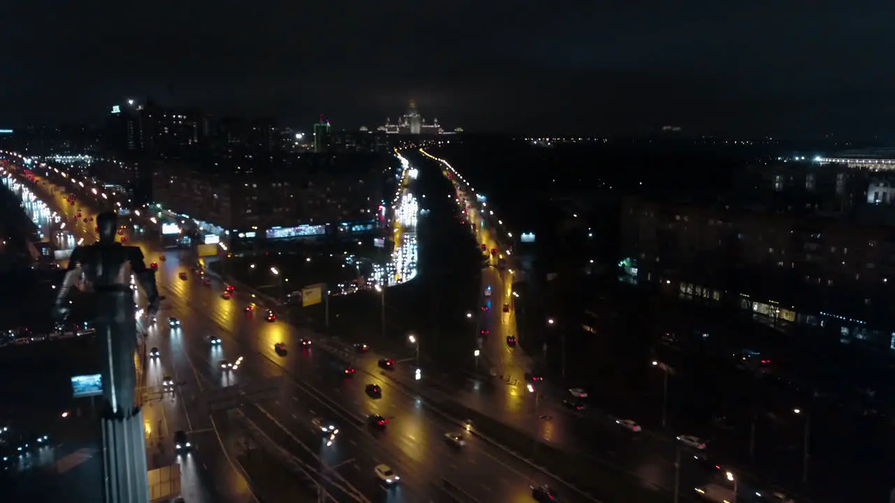 An aerial night view of a busy road against the endless urbanscape