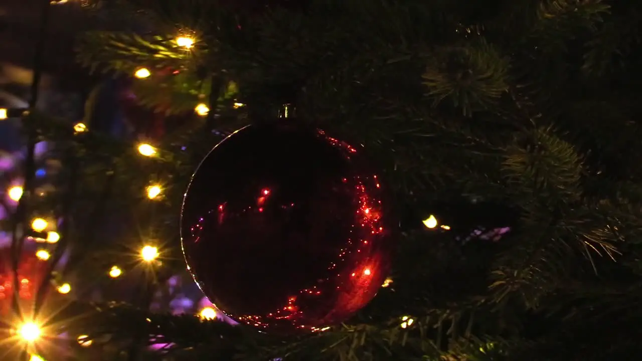 Still shot of close up of a Christmas ball on a tree The Mansion House some lights and movement from the Christmas ball