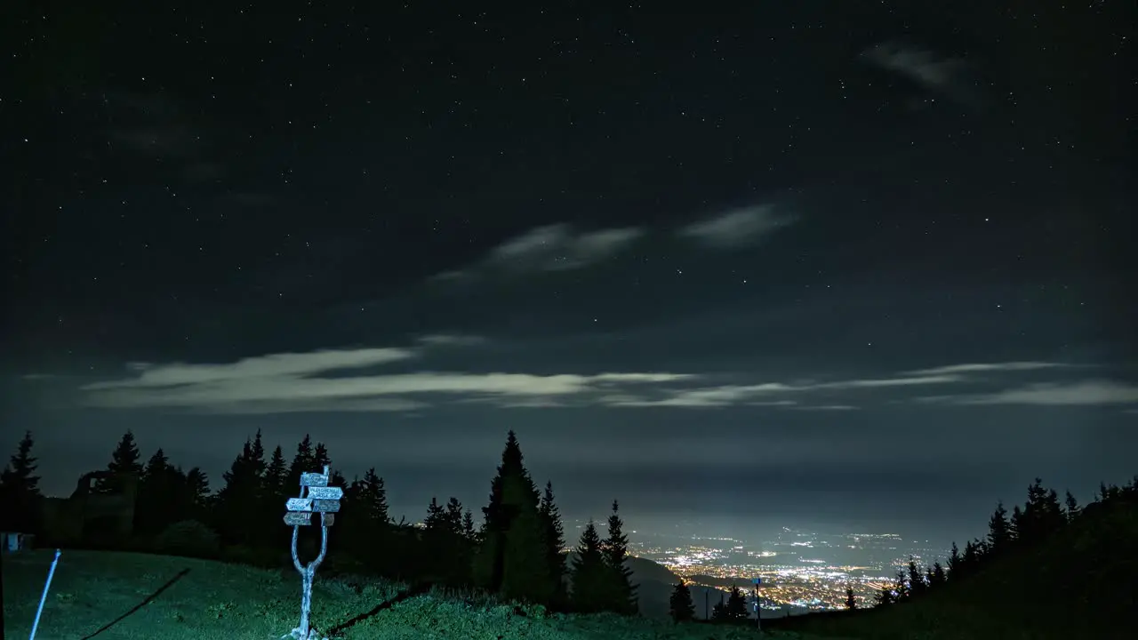 Captivating night timelapse Mountains adorned by moving clouds in a celestial dance revealing the serene beauty of the starlit sky