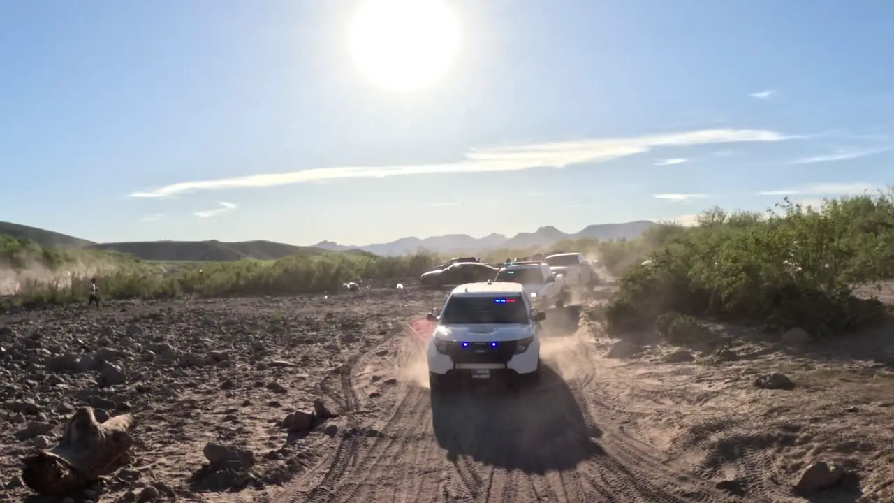 Cop car driving on a dirty road with blinking emergency police lights