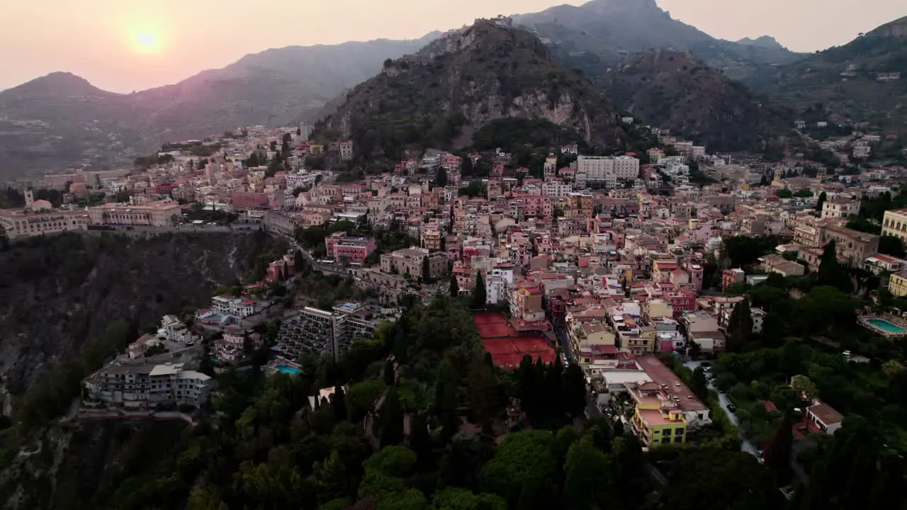 Aerial drone shot over Taormina after sunset in Sicily island