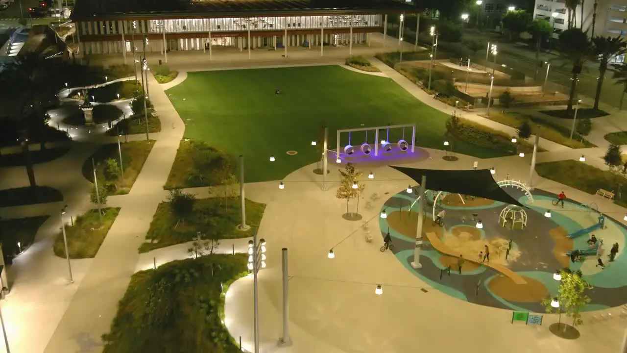 Aerial fly by shot of Lincoln Park in downtown Long Beach | Night time