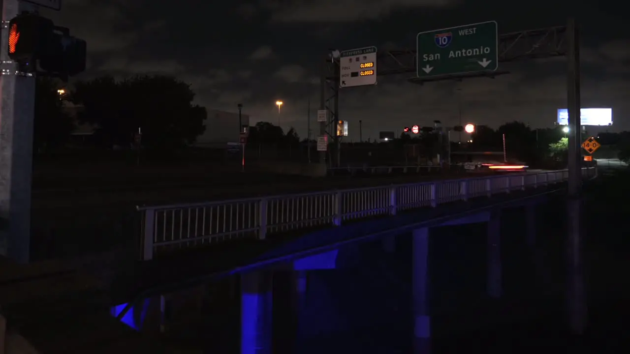 Night time lapse of traffic on entering freeway with San Antonio Sign