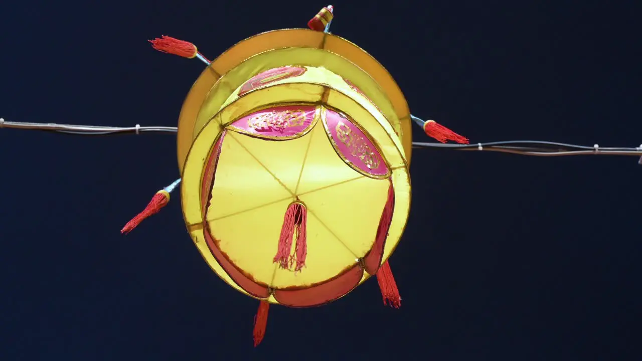 A Chinese yellow lantern which symbolize prosperity and good fortune hangs from a wire during the Mid-Autumn Festival also called Mooncake Festival