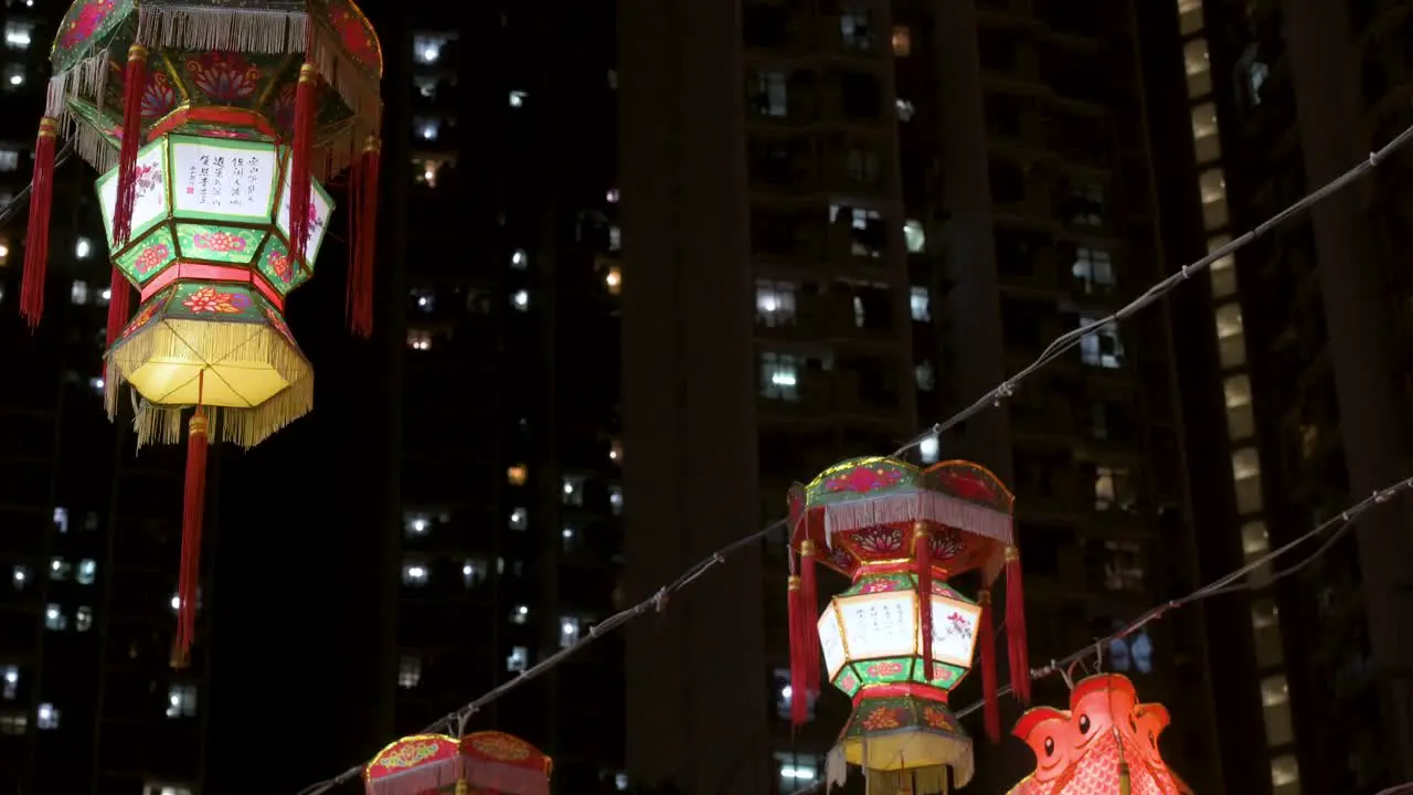 Chinese lanterns which symbolize prosperity and good fortune hang from ceiling wires near a residential urban area during the Mid-Autumn Festival also called Mooncake Festival