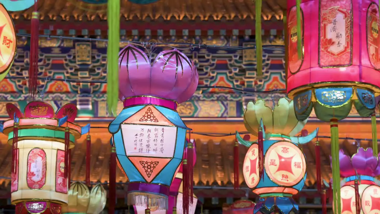 Chinese lanterns which symbolize prosperity and good fortune hang from ceiling wires next to a temple during the Mid-Autumn Festival also called Mooncake Festival