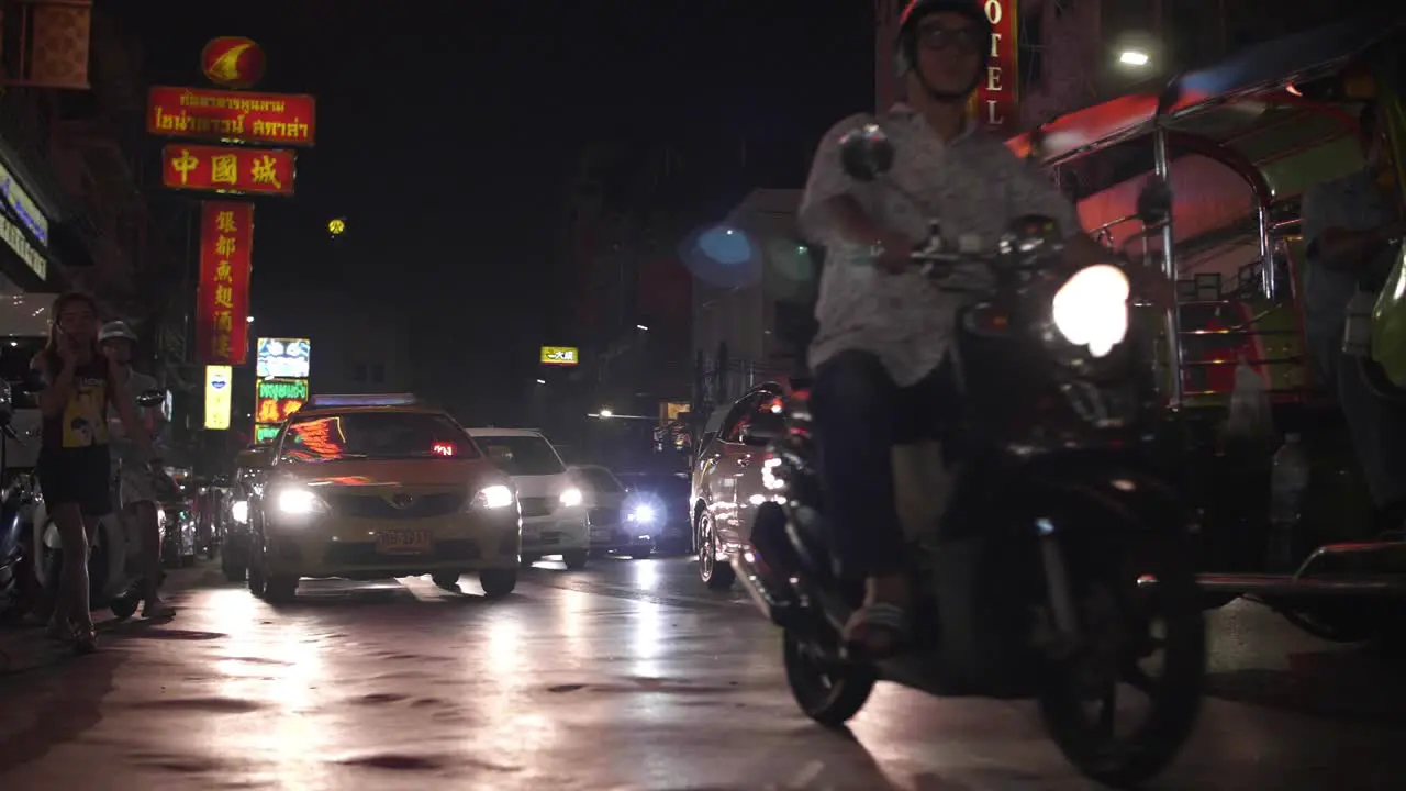 Motorcycle and Tuk Tuk at Night