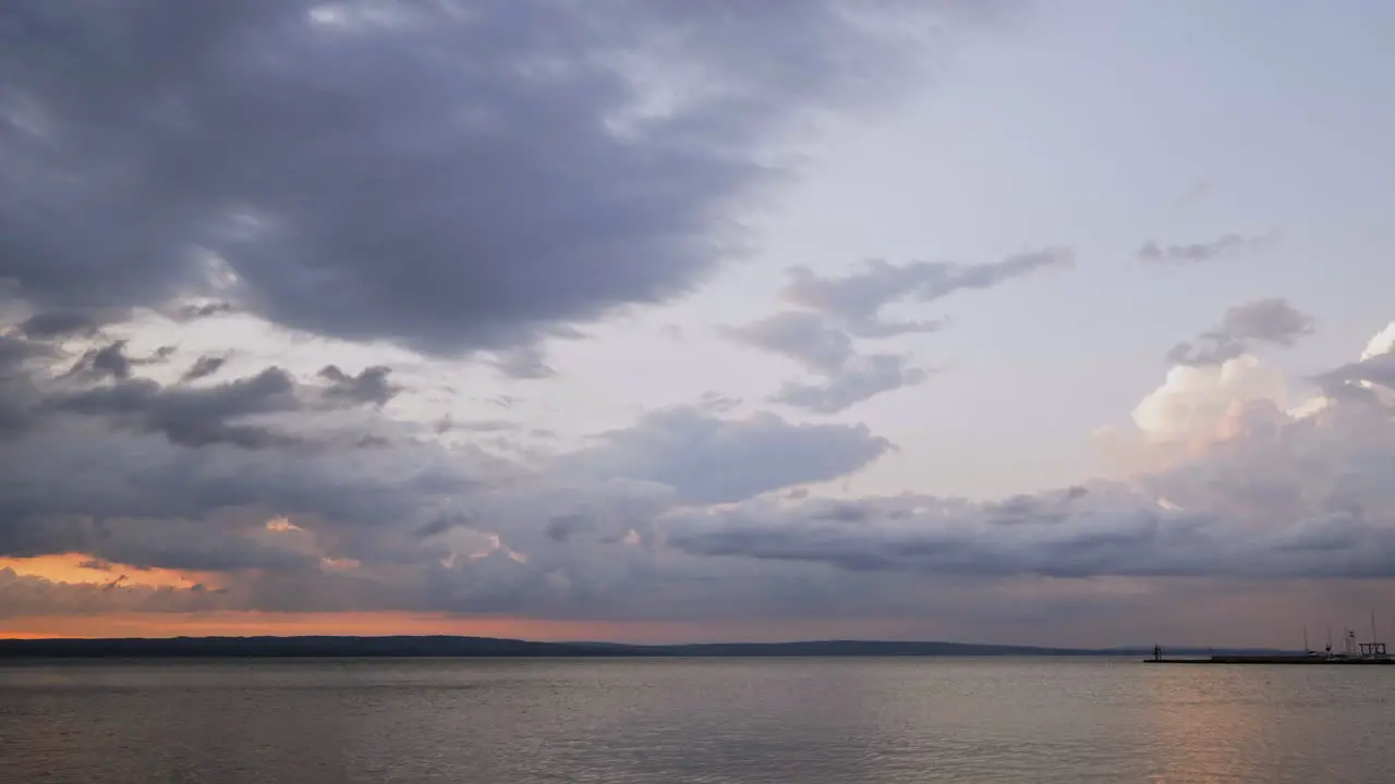 Timelapse of a Beautiful Sunset with Moving Clouds Over Large Lake