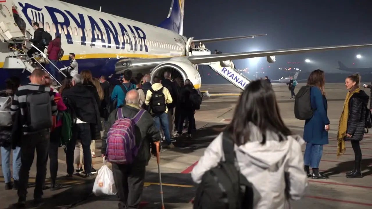 People lining up in front of a Ryanair plane