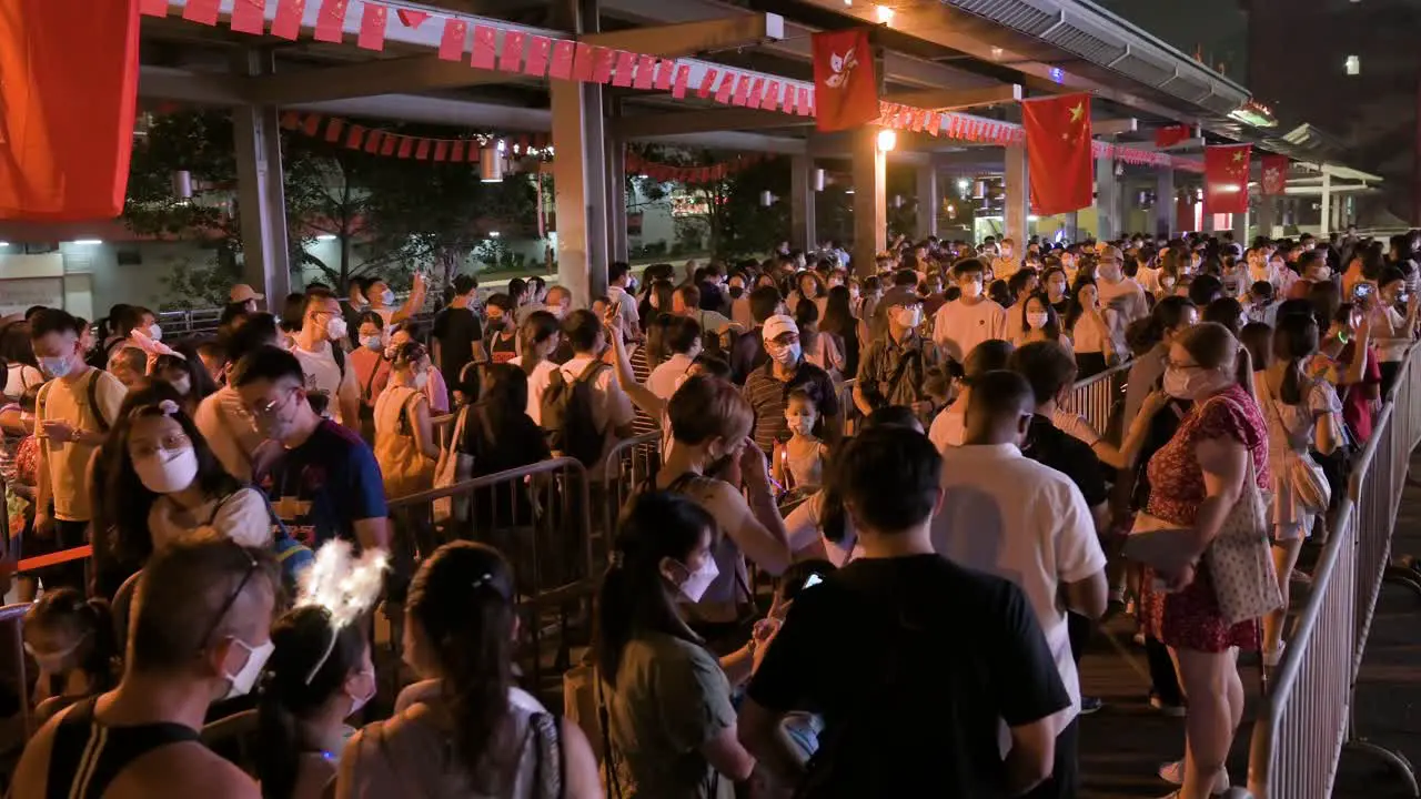 Visitors go through a long queue to enter a nighttime lantern show which symbolizes prosperity and good fortune at the Wong Tai Sin temple during the Mid-Autumn Festival 