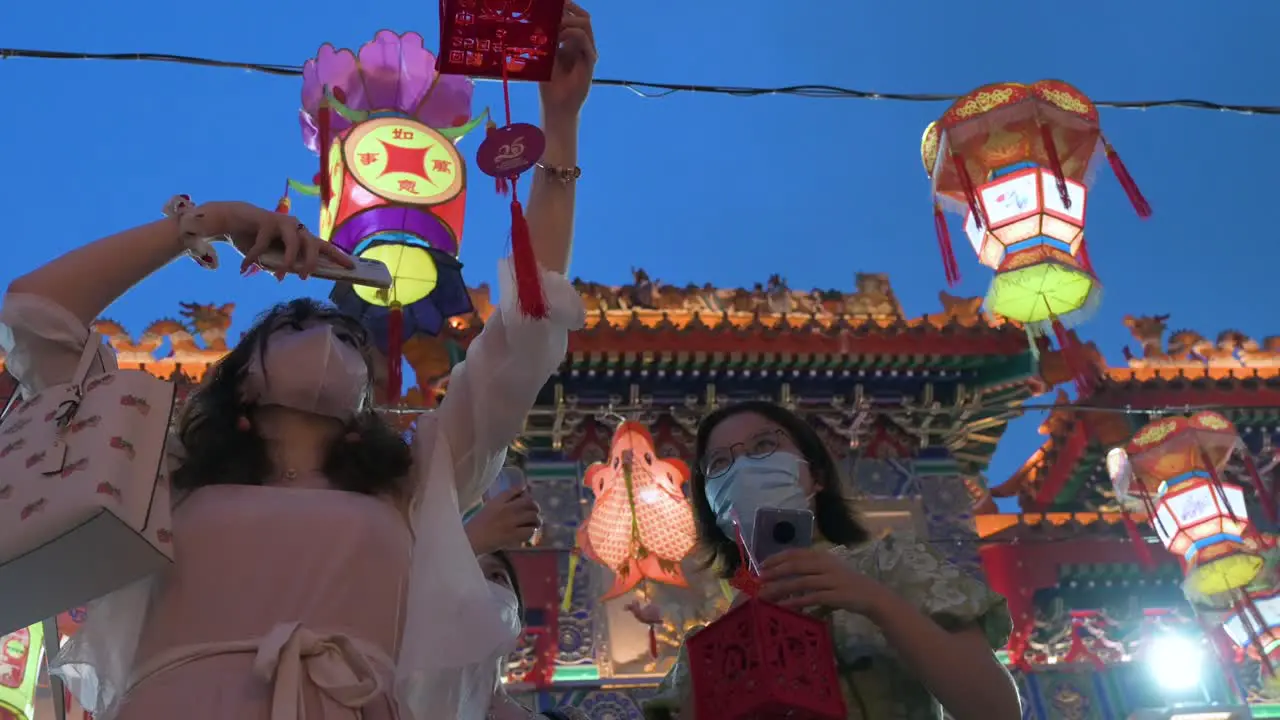 Visitors hold up lanterns which symbolize prosperity and good fortune at the Wong Tai Sin temple to celebrate the Mid-Autumn Festival also called Mooncake Festival