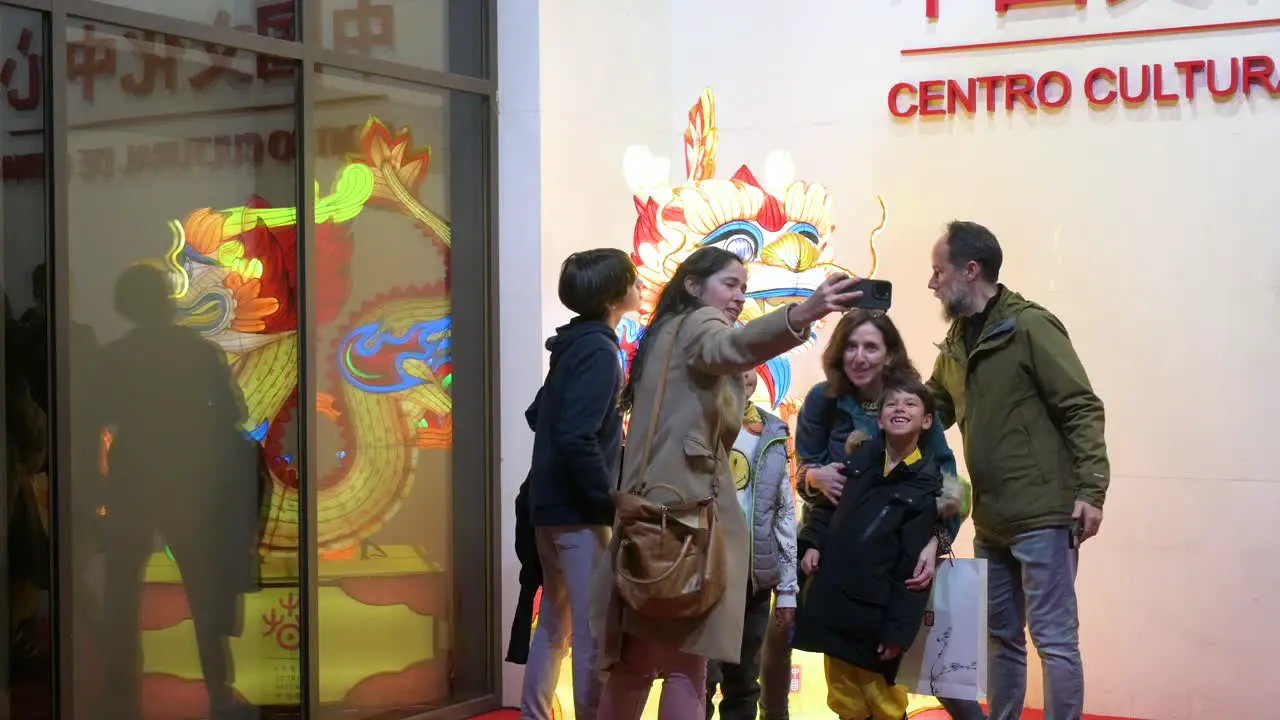 Visitors take a selfie with a dragon lantern installation outside the China Cultural Centre to mark the upcoming Chinese Lunar New Year 2024 the Year of the Dragon in Madrid Spain