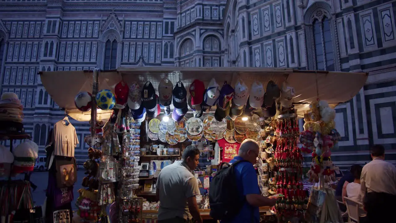 Tourist Souvenir Street Vendor Stall in Florence Italy Selling Trinkets with Florence Cathedral in Background