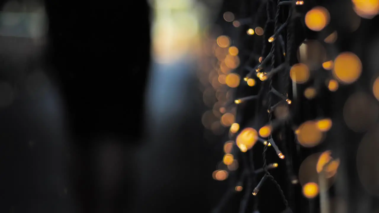 guys walking away from camera outfocus on bridge during christmas season