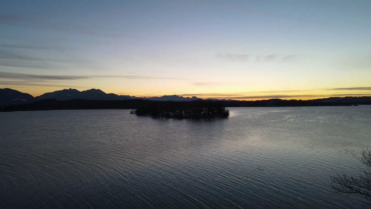 Sunset at lake with mountains and forest in Bavaria