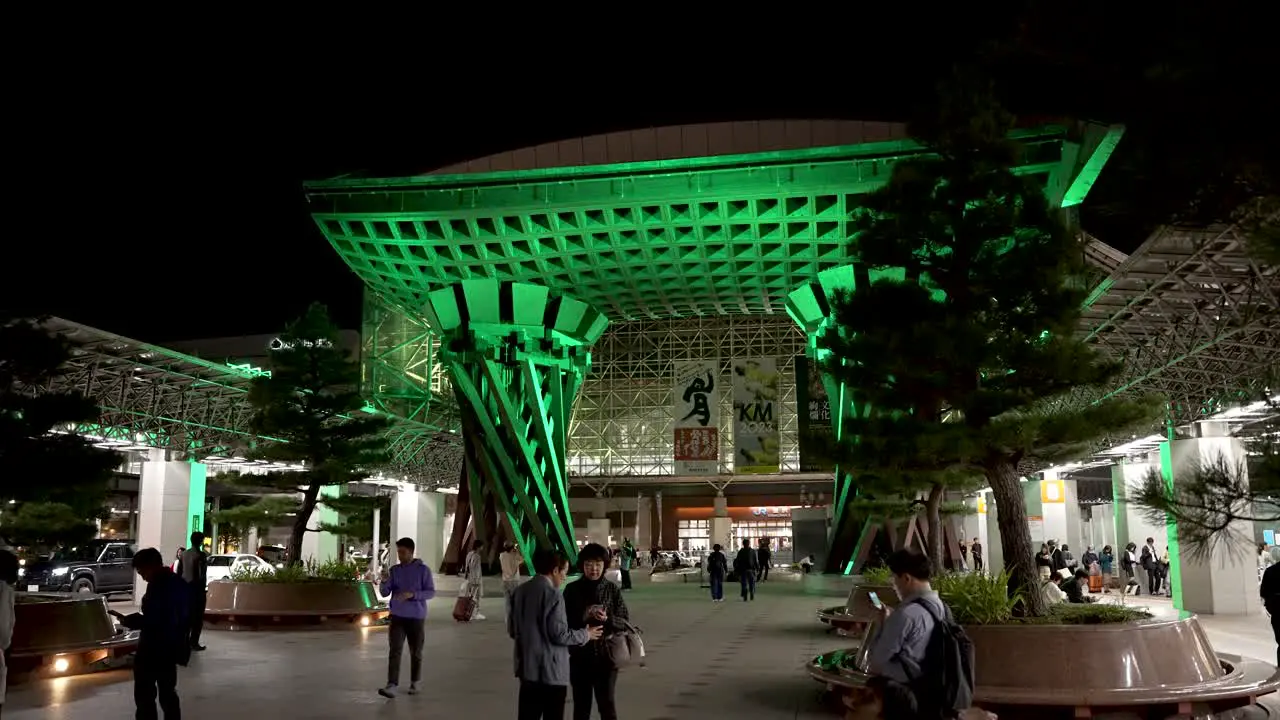 The Tsuzumi Gate at JR Kanazawa Station East light up green entrance with tourists Japan