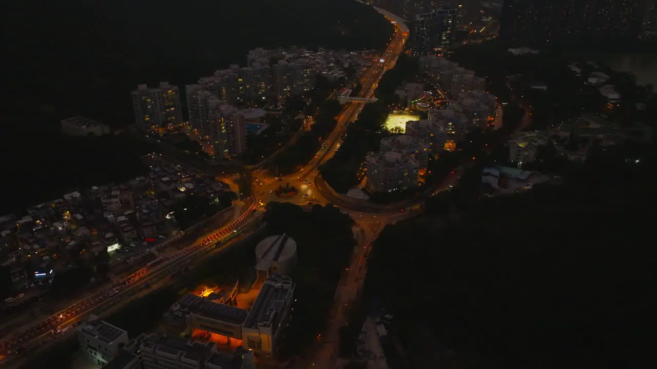 Stunning static aerial view of a city after sunset and lit-up lights