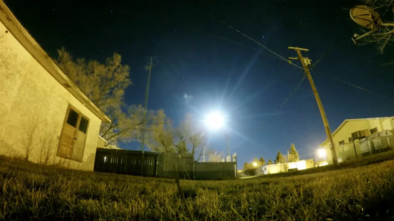 NIGHT LAPSE View of the moon between town houses in Empress Alberta Canada